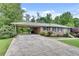 Charming brick home with a covered carport, well-manicured landscaping, and a welcoming light blue front door at 2653 Elkhart Sw Cir, Marietta, GA 30064