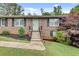 Inviting brick home with a light-blue front door, landscaped garden, and well-kept lawn at 2653 Elkhart Sw Cir, Marietta, GA 30064