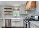 Stylish kitchen showcasing a farmhouse sink, stainless steel appliances, and modern backsplash at 2653 Elkhart Sw Cir, Marietta, GA 30064