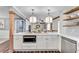 Bright kitchen boasts white cabinets, quartz counters, and modern stainless steel appliances at 2653 Elkhart Sw Cir, Marietta, GA 30064