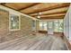 Relaxing sunroom with brick accent wall, wood ceiling, and plenty of natural light at 2653 Elkhart Sw Cir, Marietta, GA 30064