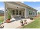 Cozy covered back patio with a seating area and well-maintained landscaping at 3219 Blackshear Dr, Marietta, GA 30060