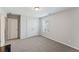 Neutral bedroom with gray carpet, double door closet, and window at 3219 Blackshear Dr, Marietta, GA 30060