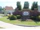 McGinnis Farm community entrance sign surrounded by beautiful landscaping and colorful flowerbeds at 3219 Blackshear Dr, Marietta, GA 30060