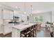 Modern kitchen with white cabinets, a large island, stainless steel appliances, and an adjacent dining area at 3219 Blackshear Dr, Marietta, GA 30060