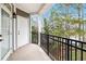 View of a condo balcony with black metal railing, door, and view of trees at 4100 Paces Se Walk # 2304, Atlanta, GA 30339