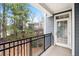 View of a condo balcony with black metal railing and partial view of trees and nearby building at 4100 Paces Se Walk # 2304, Atlanta, GA 30339