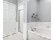 Bathroom featuring a soaking tub and a glass-enclosed shower, alongside white tile at 4100 Paces Se Walk # 2304, Atlanta, GA 30339