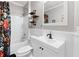 Well-lit bathroom with a shower-tub, white vanity, and decorative shelving at 4100 Paces Se Walk # 2304, Atlanta, GA 30339