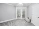 Bright bedroom featuring neutral walls, carpet, a ceiling fan, and glass doors leading to an outdoor space at 4100 Paces Se Walk # 2304, Atlanta, GA 30339