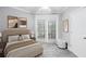 Comfortable bedroom showcasing a bed, a window, and a door with access to the patio at 4100 Paces Se Walk # 2304, Atlanta, GA 30339