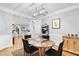 Open dining room with hardwood floors, wainscoting and a modern light fixture at 4100 Paces Se Walk # 2304, Atlanta, GA 30339