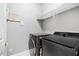 Well-lit laundry room with modern washer and dryer units and wire shelving for storage at 4100 Paces Se Walk # 2304, Atlanta, GA 30339