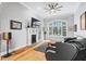 Bright living room with a large window, fireplace, hardwood floors, and modern ceiling fan at 4100 Paces Se Walk # 2304, Atlanta, GA 30339