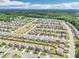 Expansive aerial view of neighborhood with well-kept homes, green spaces, and community layout at 66 Cottontail Ln, Loganville, GA 30052