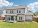 Back exterior view highlighting the covered patio, well-maintained siding, and green backyard at 66 Cottontail Ln, Loganville, GA 30052