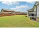Spacious backyard featuring a well-maintained lawn, wooden fence, and covered patio at 66 Cottontail Ln, Loganville, GA 30052