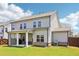 Exterior view of the home's back featuring a covered patio and fenced yard at 66 Cottontail Ln, Loganville, GA 30052