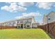Exterior of home with large backyard, wooden fence and covered patio at 66 Cottontail Ln, Loganville, GA 30052