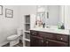Bathroom featuring a wooden vanity, toilet, and built-in storage at 66 Cottontail Ln, Loganville, GA 30052