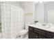 Bathroom with shower, tub and dark wood cabinets at 66 Cottontail Ln, Loganville, GA 30052
