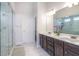 Elegant bathroom featuring a glass shower, double vanity, and neutral tones at 66 Cottontail Ln, Loganville, GA 30052