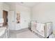 Well-lit Bedroom with a modern crib and a view to the doorway at 66 Cottontail Ln, Loganville, GA 30052