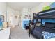Bedroom with bunk beds with blue accent wall and gaming accessories at 66 Cottontail Ln, Loganville, GA 30052