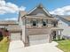 Two-story home featuring a two-car garage and an additional one-car garage at 66 Cottontail Ln, Loganville, GA 30052