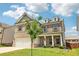 Two-story home with brick and siding exterior, and a welcoming front porch at 66 Cottontail Ln, Loganville, GA 30052