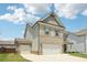 Two-story home featuring a two-car garage and an additional one-car garage at 66 Cottontail Ln, Loganville, GA 30052