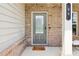 Inviting front entrance with a welcome mat and a view of the home's exterior at 66 Cottontail Ln, Loganville, GA 30052