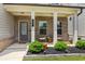 Charming front porch with brick accents, cozy seating, and manicured landscaping at 66 Cottontail Ln, Loganville, GA 30052