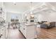 Open kitchen view with island, stainless appliances, and nearby dining area and living room with fireplace at 66 Cottontail Ln, Loganville, GA 30052