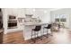Bright kitchen with granite countertops, stainless steel appliances, and an island with bar stool seating at 66 Cottontail Ln, Loganville, GA 30052