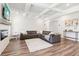 Bright living room with coffered ceilings, wood floors, fireplace, and a stylish leather sectional sofa at 66 Cottontail Ln, Loganville, GA 30052
