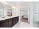 Bright primary bathroom boasts double vanity, modern fixtures, and a seamless glass shower at 66 Cottontail Ln, Loganville, GA 30052