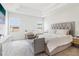 Spacious main bedroom with a tray ceiling, a large bed, and natural light at 66 Cottontail Ln, Loganville, GA 30052