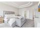 Bedroom with plush carpeting, coffered ceiling, and access to ensuite bathroom at 66 Cottontail Ln, Loganville, GA 30052