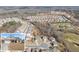 Aerial view of the home and neighborhood with wooded views at 7995 Brewton Creek Dr, Cumming, GA 30028