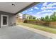 Covered back patio and fenced yard with lawn, backing up to mature trees at 7995 Brewton Creek Dr, Cumming, GA 30028