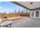 Covered back patio looking out to a fenced backyard and lawn at 7995 Brewton Creek Dr, Cumming, GA 30028