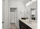 Bathroom with dark wood vanity, neutral tile floor, and a view of the shower with white curtain at 7995 Brewton Creek Dr, Cumming, GA 30028