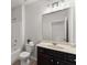 Bathroom featuring a vanity, toilet, shower-tub combo and large mirror, with neutral colors at 7995 Brewton Creek Dr, Cumming, GA 30028
