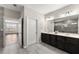 Spacious bathroom featuring a double vanity with dark wood cabinets and a tile floor at 7995 Brewton Creek Dr, Cumming, GA 30028