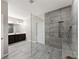 The bathroom features a glass shower, gray tiled walls, and modern fixtures at 7995 Brewton Creek Dr, Cumming, GA 30028