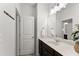 Bathroom with a dark wood vanity, white countertop, decorative mirror, and access to the shower at 7995 Brewton Creek Dr, Cumming, GA 30028