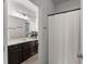 Bathroom featuring a vanity with dark wood cabinets and a shower with a white curtain at 7995 Brewton Creek Dr, Cumming, GA 30028