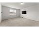 Bonus room featuring carpet flooring, a window, and a mounted TV at 7995 Brewton Creek Dr, Cumming, GA 30028