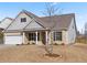 Beautiful home exterior with manicured lawn, covered porch, and neutral color scheme creating a welcoming curb appeal at 7995 Brewton Creek Dr, Cumming, GA 30028